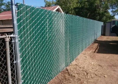 chain link fence with green privacy slats